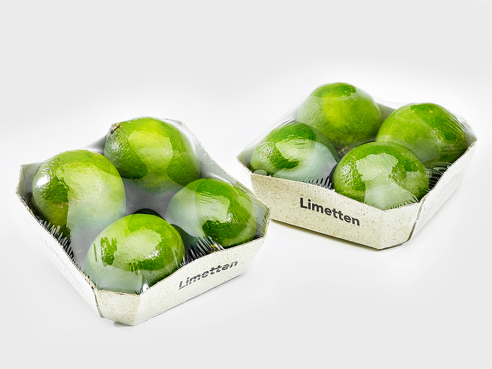 Limetten im Karton-Tray, verpackt in Polyolefin-Feinschrumpffolie